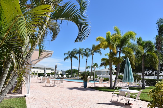 view of property's community featuring a swimming pool and a patio area