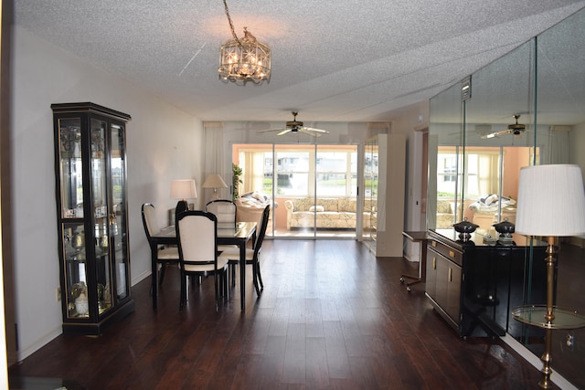 dining area with dark hardwood / wood-style floors, a textured ceiling, and ceiling fan with notable chandelier