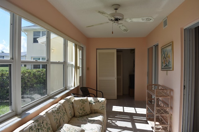 sunroom / solarium featuring ceiling fan