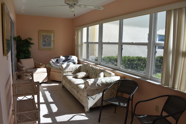 living room with dark tile flooring and ceiling fan