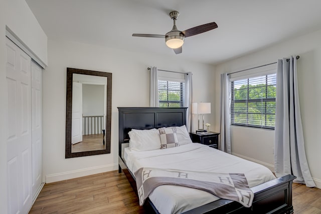 bedroom with a closet, ceiling fan, and light wood-type flooring