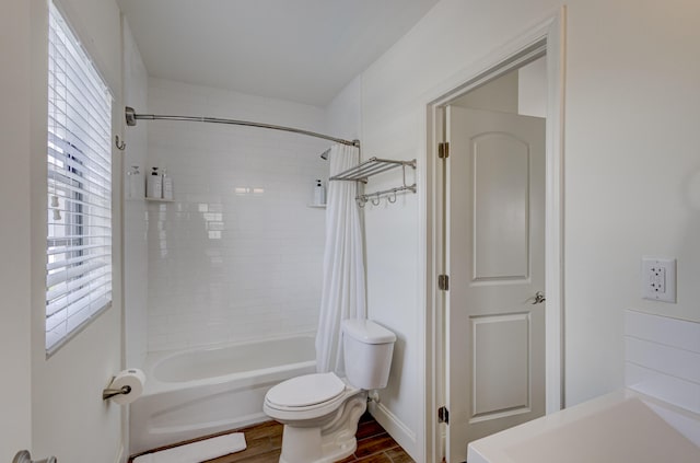 bathroom featuring shower / tub combo, toilet, and hardwood / wood-style flooring