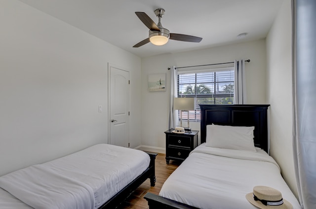 bedroom with ceiling fan and dark hardwood / wood-style flooring