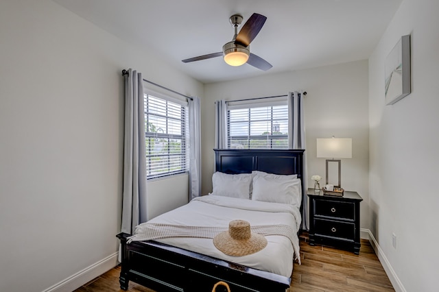 bedroom with ceiling fan and hardwood / wood-style flooring