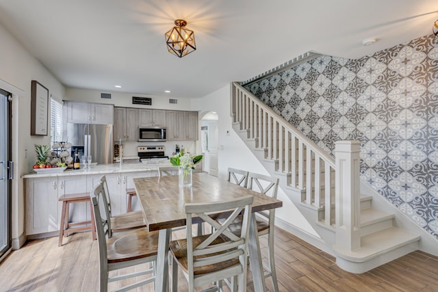 dining room with a chandelier and light wood-type flooring