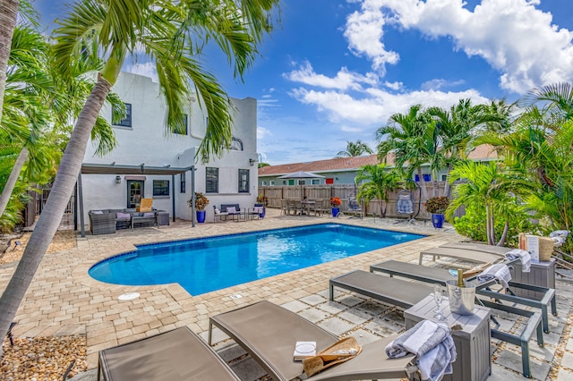 view of pool with outdoor lounge area and a patio