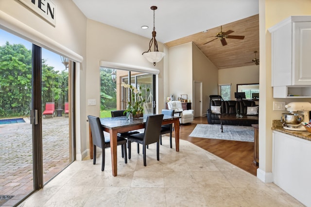 dining room featuring high vaulted ceiling, ceiling fan, and light tile flooring