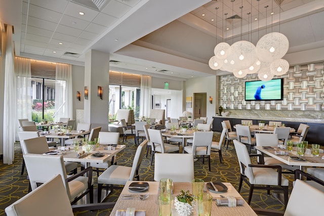 dining area with a high ceiling and a tray ceiling