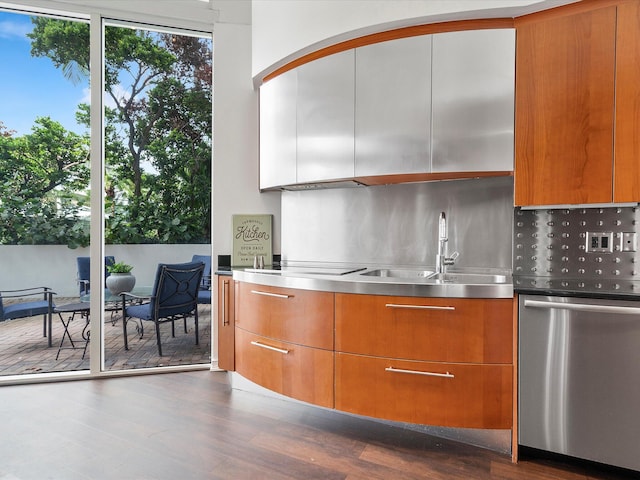 kitchen with stainless steel counters, tasteful backsplash, sink, and dark hardwood / wood-style floors