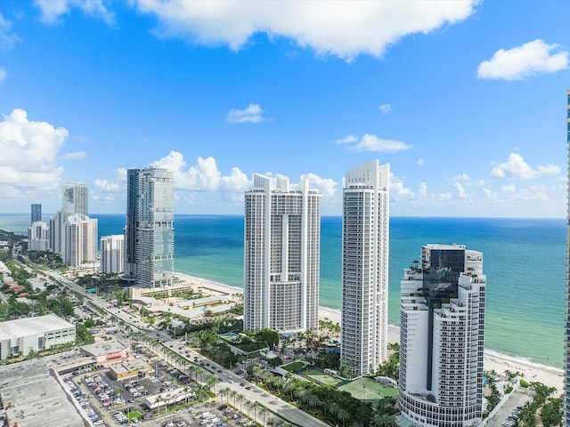 birds eye view of property featuring a beach view and a water view