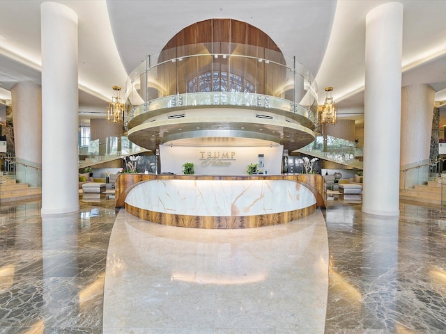 reception with decorative columns and a chandelier