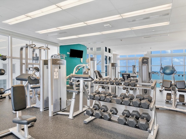 exercise room featuring a drop ceiling