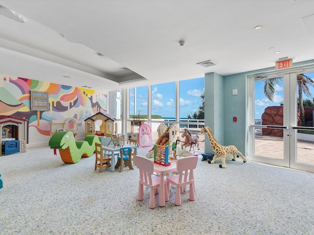 playroom with light carpet and french doors