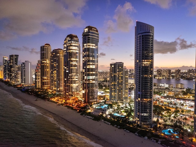 property's view of city with a view of the beach and a water view