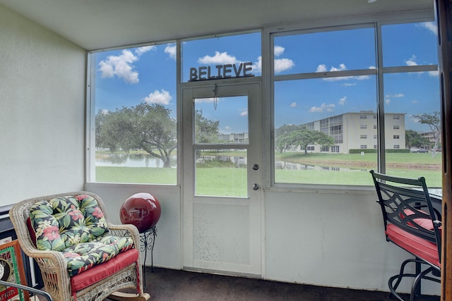 sunroom / solarium featuring a water view and a wealth of natural light