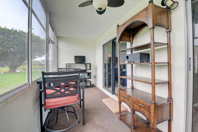 sunroom / solarium featuring ceiling fan