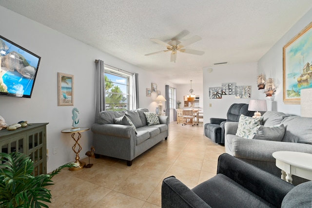 tiled living room featuring a textured ceiling and ceiling fan