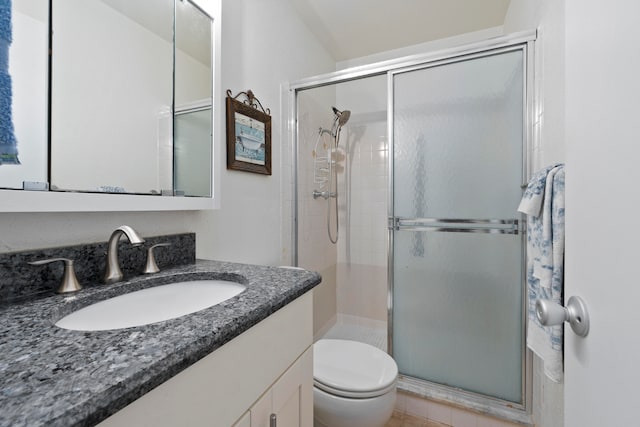 bathroom with walk in shower, toilet, and vanity