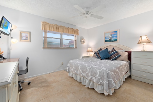 bedroom with a textured ceiling, light tile flooring, and ceiling fan