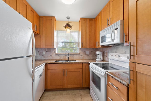 kitchen with white appliances, sink, light tile floors, light stone counters, and tasteful backsplash