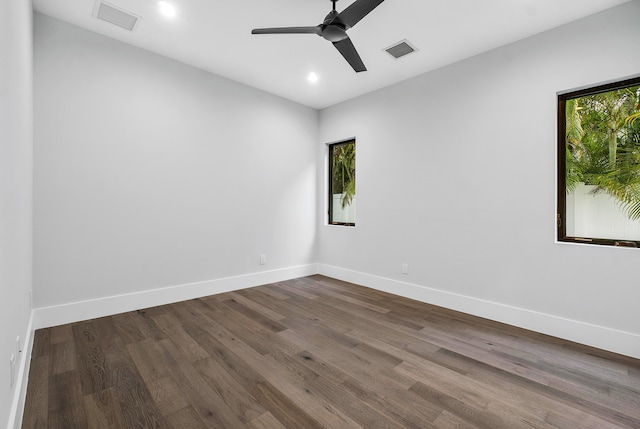 spare room featuring dark hardwood / wood-style flooring and ceiling fan