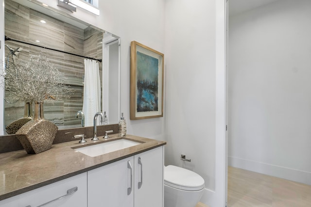 bathroom with toilet and vanity