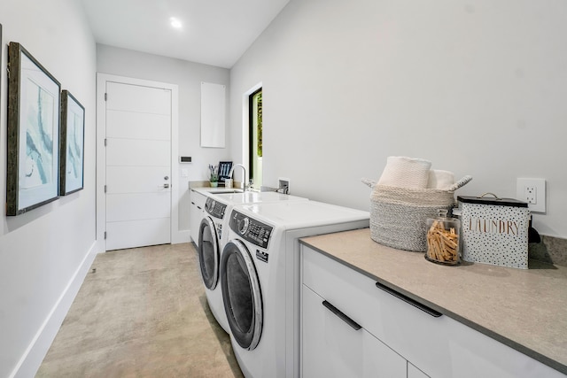 washroom featuring sink, cabinets, washing machine and clothes dryer, and hookup for a washing machine