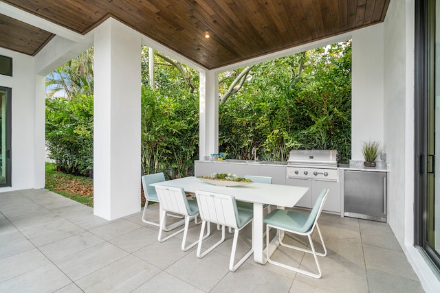 view of terrace featuring a grill and exterior kitchen