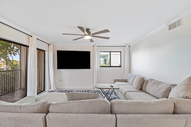 living room with crown molding and ceiling fan