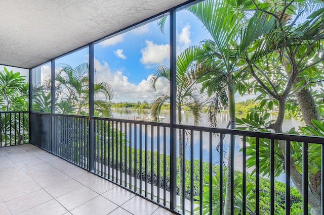 unfurnished sunroom featuring a water view