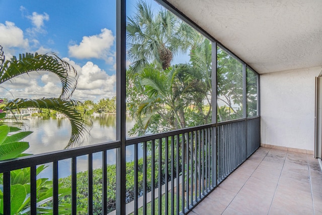 unfurnished sunroom featuring a water view