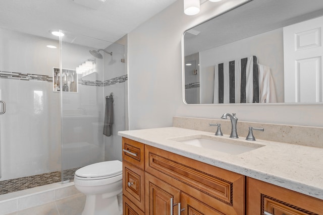 bathroom with toilet, a shower with door, tile floors, and vanity