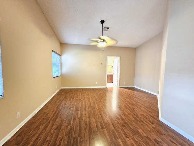 unfurnished room featuring dark hardwood / wood-style floors, a textured ceiling, and ceiling fan