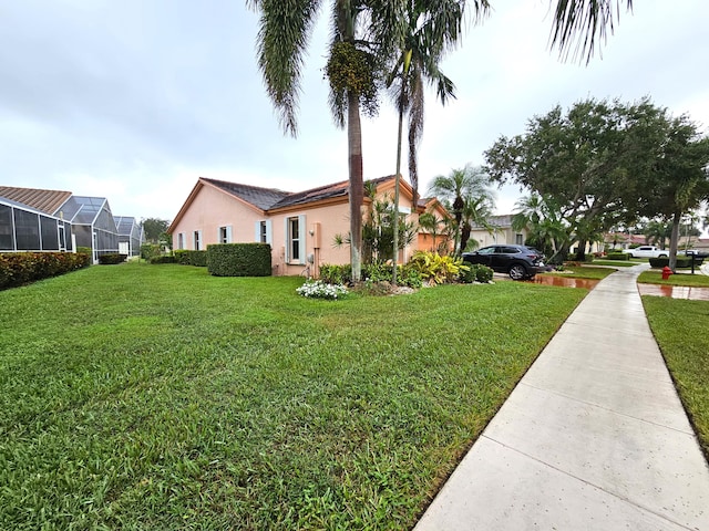 exterior space with a front lawn and a lanai