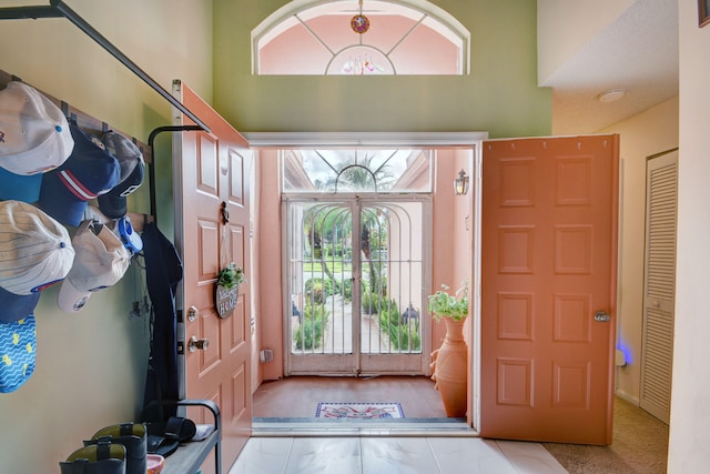 foyer entrance featuring light hardwood / wood-style flooring and a high ceiling