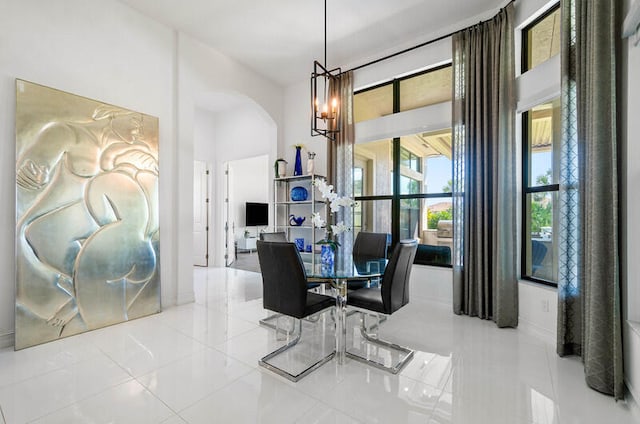 dining area featuring a notable chandelier and light tile floors