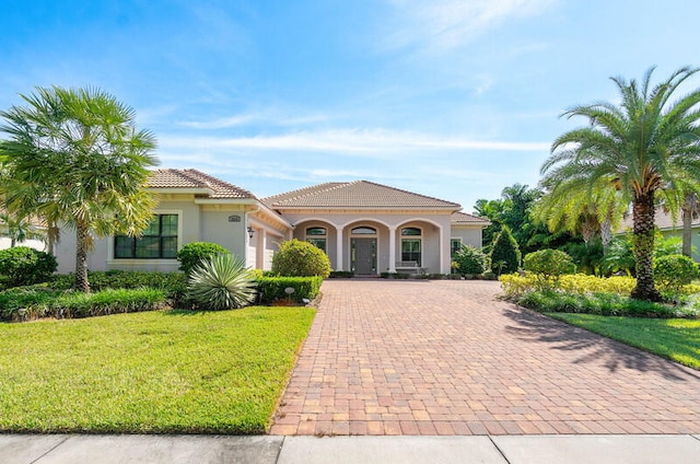 mediterranean / spanish-style house with a front yard