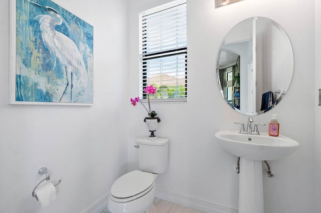 bathroom with tile flooring and toilet