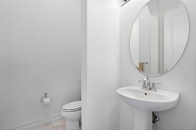 bathroom with toilet and tile flooring