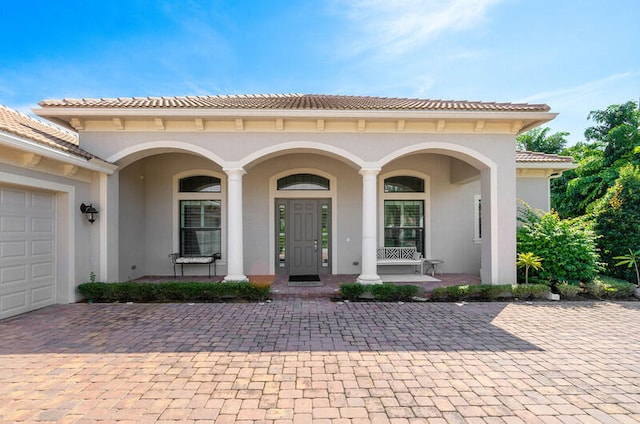 exterior space with covered porch and a garage