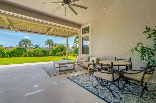 view of terrace with outdoor lounge area and ceiling fan