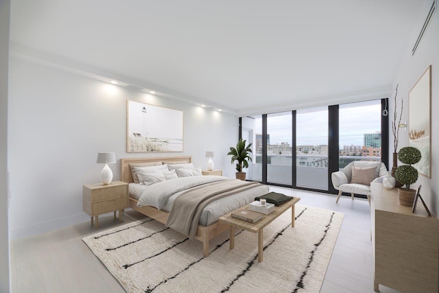 bedroom with access to outside, light hardwood / wood-style floors, and floor to ceiling windows