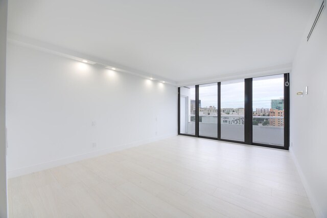 empty room with light hardwood / wood-style floors