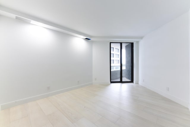 unfurnished room featuring light wood-type flooring