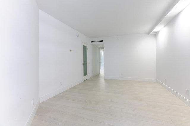 spare room featuring light hardwood / wood-style floors