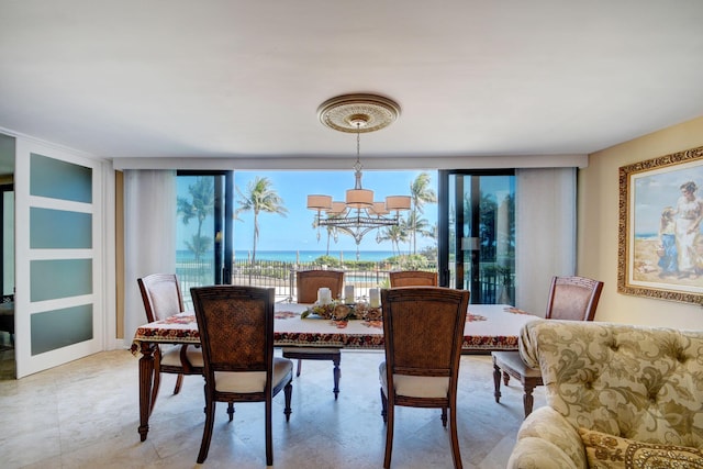 dining room with a wall of windows and an inviting chandelier