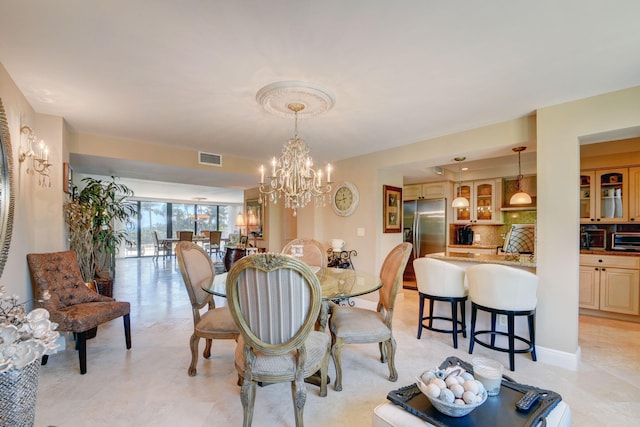 dining space featuring visible vents, a notable chandelier, and a toaster