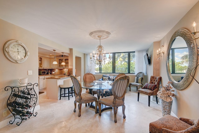 dining area featuring baseboards and a chandelier