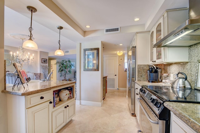 kitchen featuring visible vents, backsplash, appliances with stainless steel finishes, and extractor fan