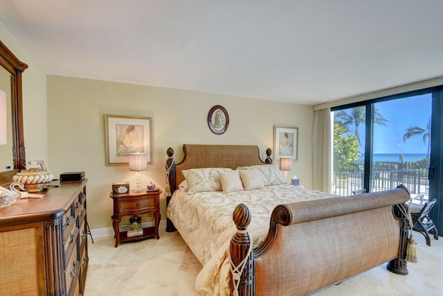 bedroom featuring access to exterior and baseboards